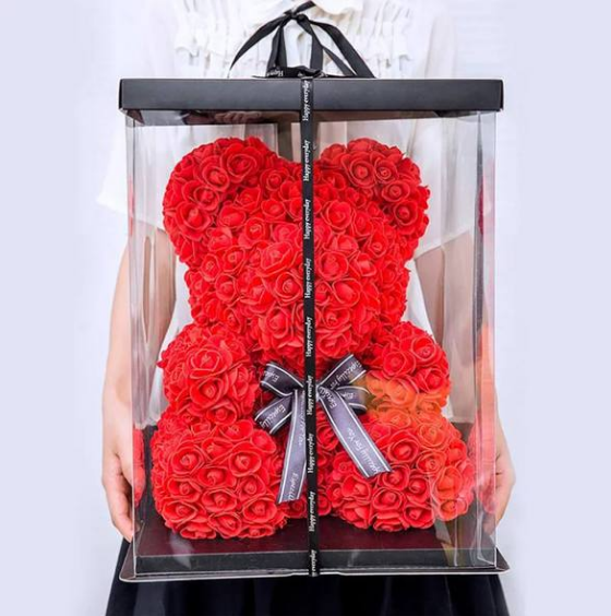 a red rose teddy bear in a box